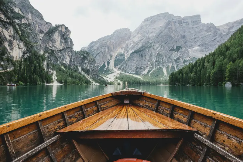 A wooden rowing boat on a mountain lake in the Dolomites